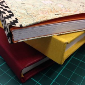 Stack of three hand-bound books