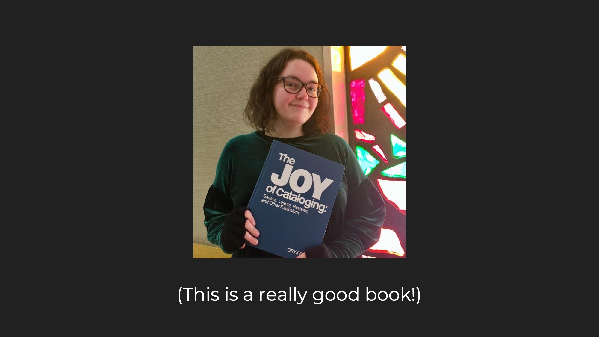 Picture of me holding the book 'The Joy of Cataloguing' by Sanford Berman, captioned 'This is a really good book!'