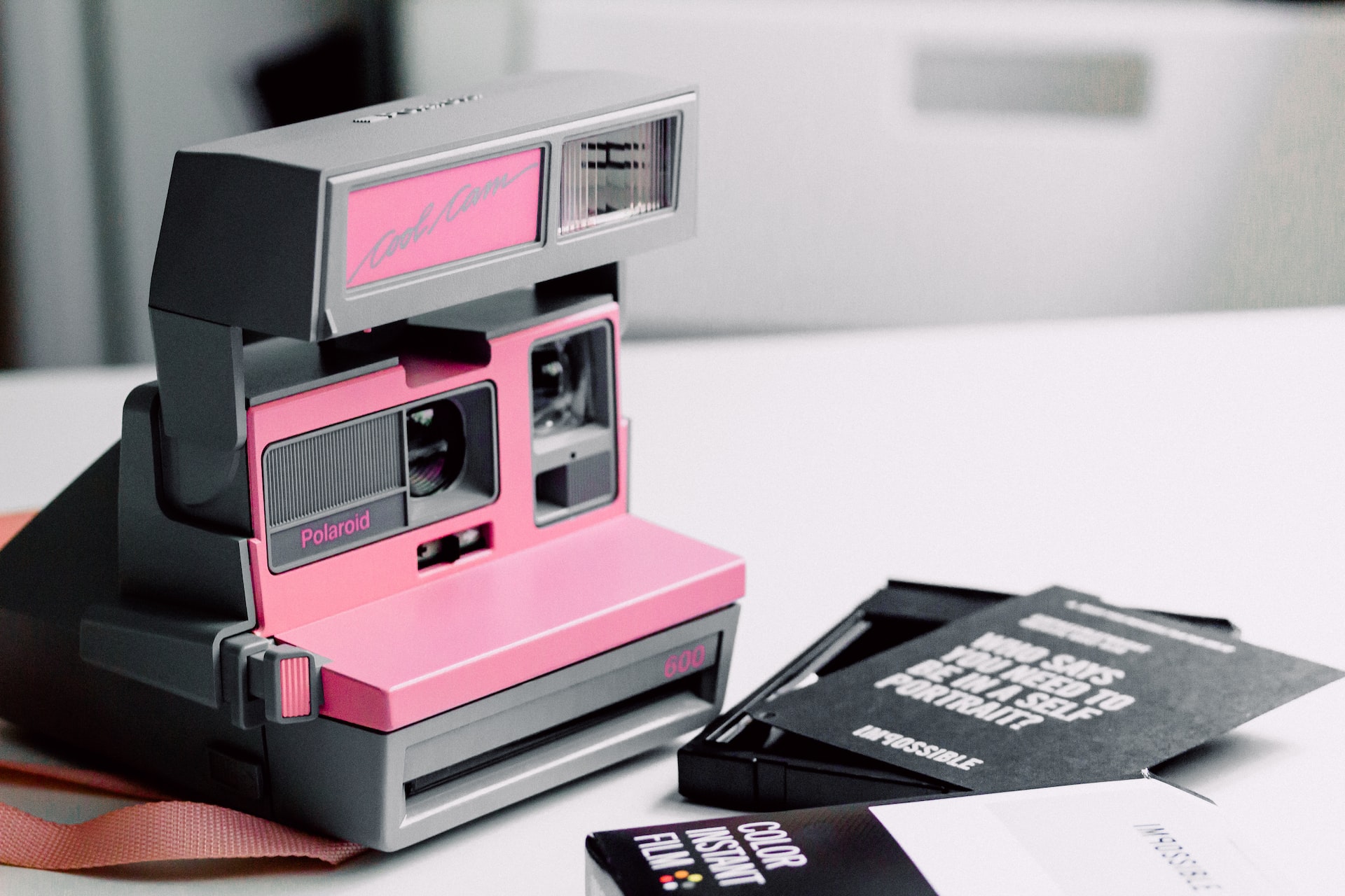 Pink and grey Polaroid camera